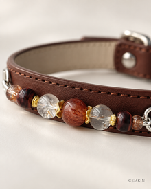 Close-up of red tiger’s-eye and black-gold Super Seven beads on GEMKIN dog collar